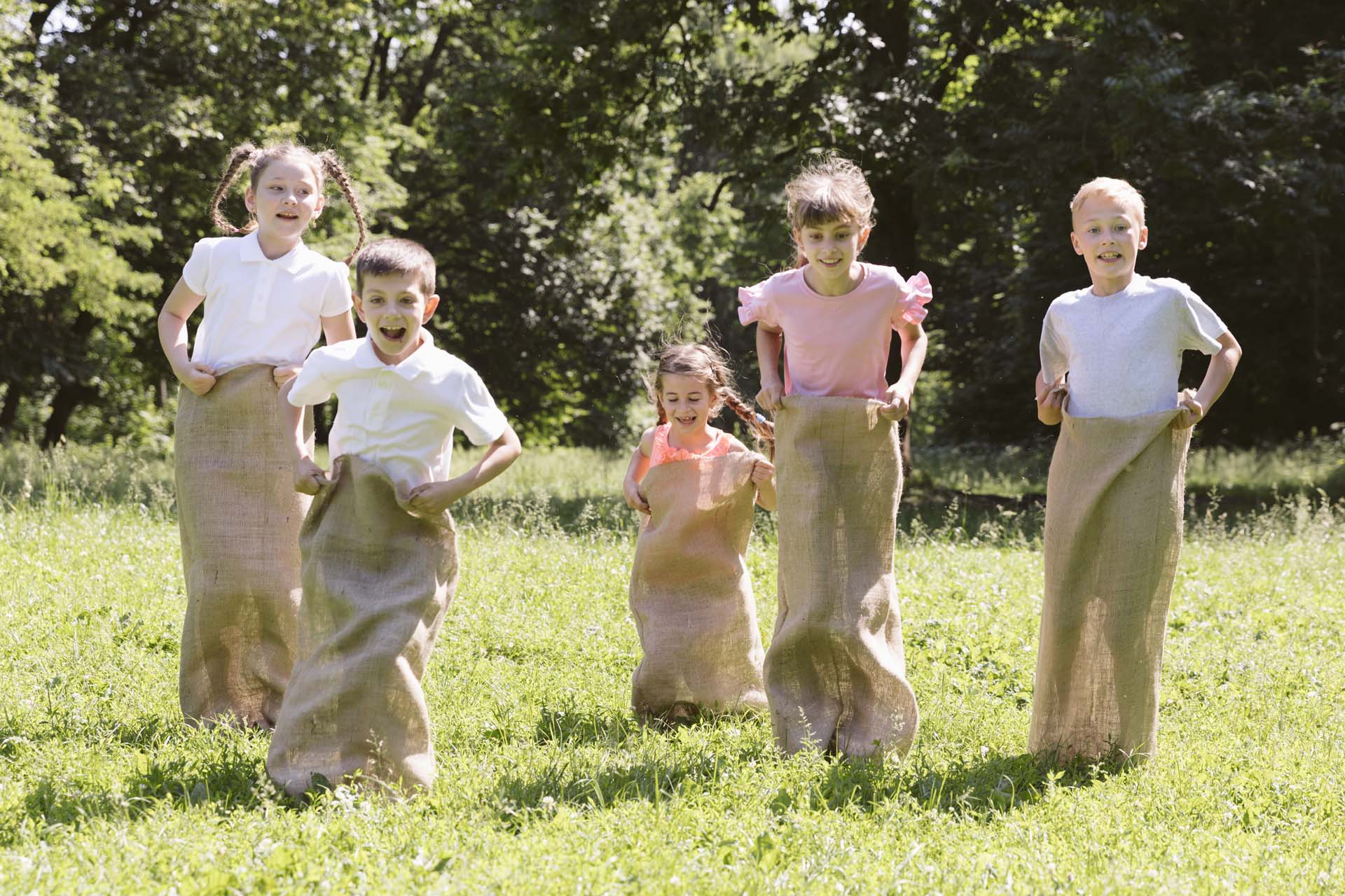 friends-having-contest-with-burlap-bags